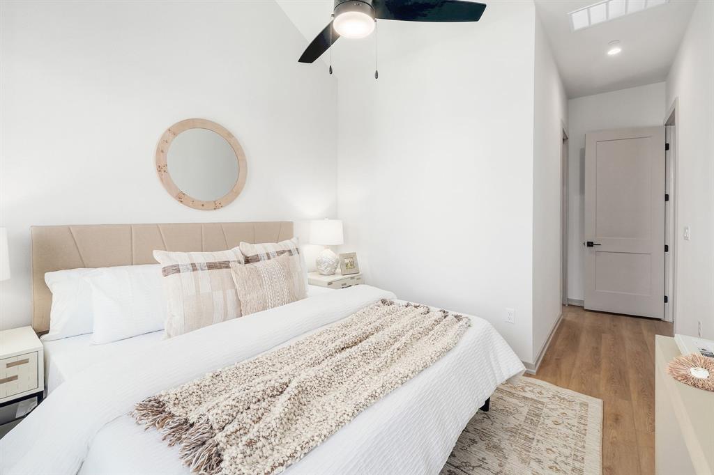 1732 Bunche Road, Unit B2 Austin, TX 78721 - Photo 12 of 22 a bedroom with a bed and a chandelier