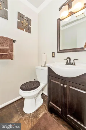 a bathroom with a sink toilet and mirror