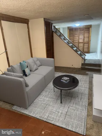 a view of an empty room with a fireplace and a window