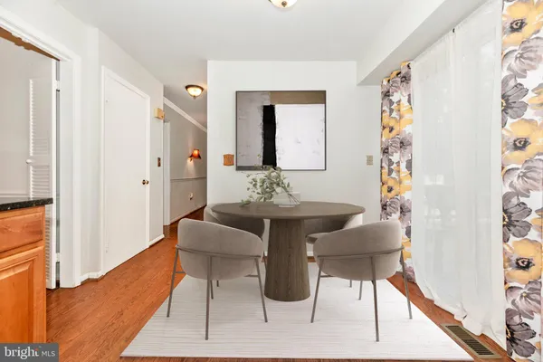 a dining room with furniture and wooden floor