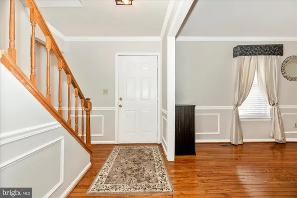 a view of an entryway with wooden floor