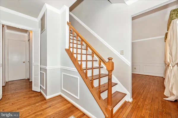 a view of an entryway with wooden floor and door