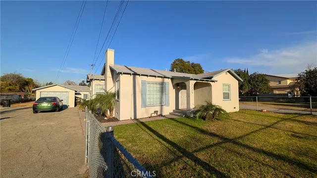 a view of a house with couches chairs and floor to ceiling window