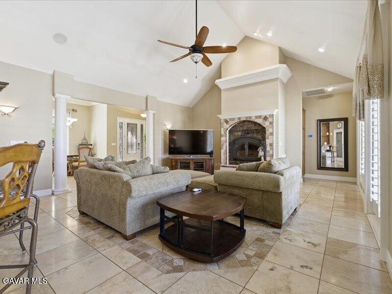 4107 Paddock Way Lancaster, CA 93536 - Photo 14 of 49 a living room with furniture a fireplace and a flat screen tv
