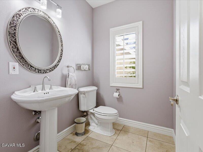 4107 Paddock Way Lancaster, CA 93536 - Photo 16 of 49 a bathroom with a sink a mirror and a toilet