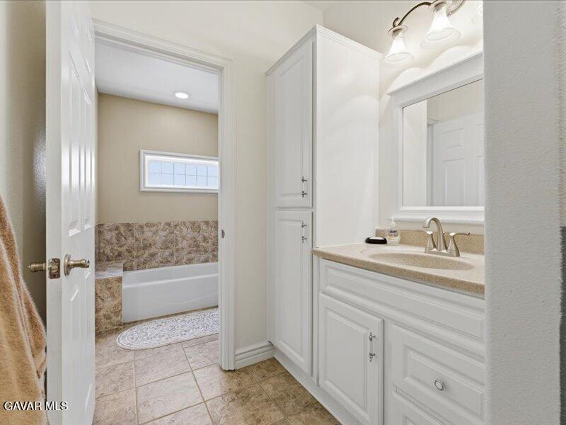 4107 Paddock Way Lancaster, CA 93536 - Photo 20 of 49 a bathroom with a sink and a mirror with bathtub