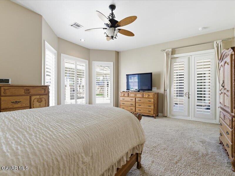 4107 Paddock Way Lancaster, CA 93536 - Photo 27 of 49 a spacious bedroom with a bed and a television