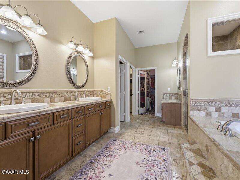 4107 Paddock Way Lancaster, CA 93536 - Photo 29 of 49 a spacious bathroom with a sink a mirror and a shower