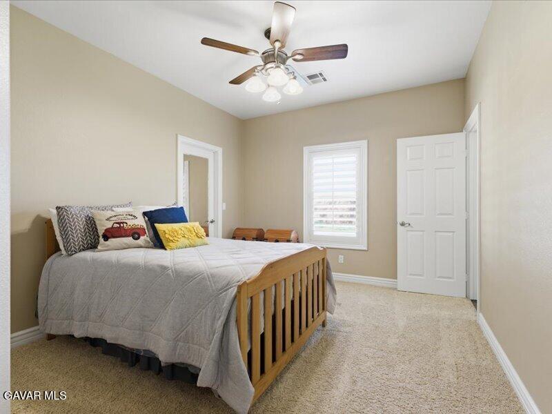 4107 Paddock Way Lancaster, CA 93536 - Photo 31 of 49 a bed room with a bed and a chandelier