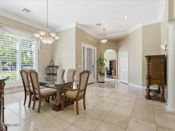 a view of a dining room with furniture and chandelier
