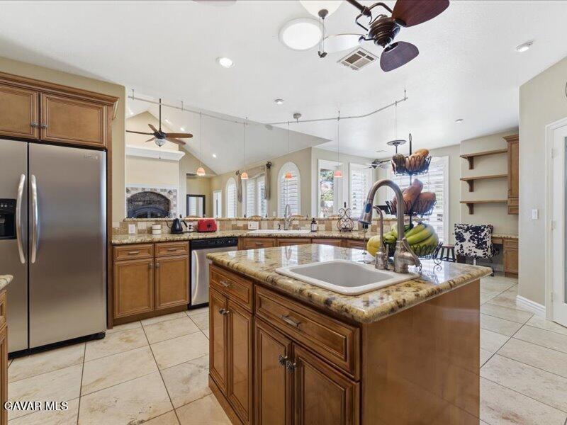 4107 Paddock Way Lancaster, CA 93536 - Photo 9 of 49 a kitchen with stainless steel appliances granite countertop a sink a counter space and stainless steel appliances