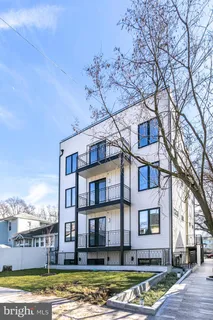 a front view of a residential apartment building with a yard