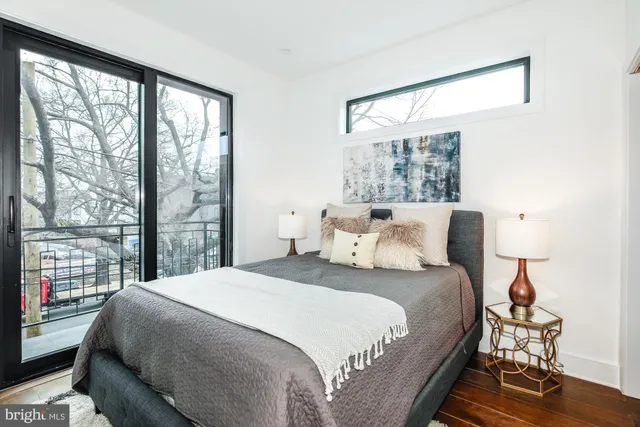 a bedroom with a large bed and a large window