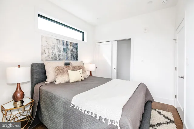 a bedroom with bed and window