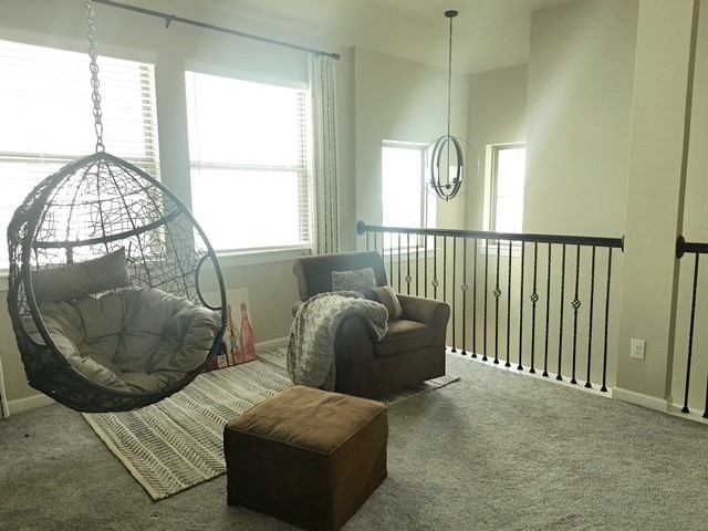 4910 Anders Lane Rosharon, TX 77583 - Photo 3 of 3 Spacious upstairs loft with carpeted flooring, abundant natural light, and an open view overlooking the main living area.