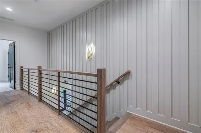 a spacious bedroom with a bed and a painting on the wall