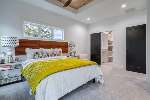 a bedroom with a bed and a mirror