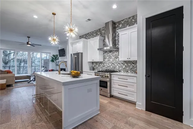 a kitchen with a sink a counter space and stainless steel appliances