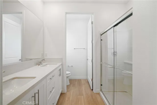 a bathroom with a granite countertop sink a mirror and a shower