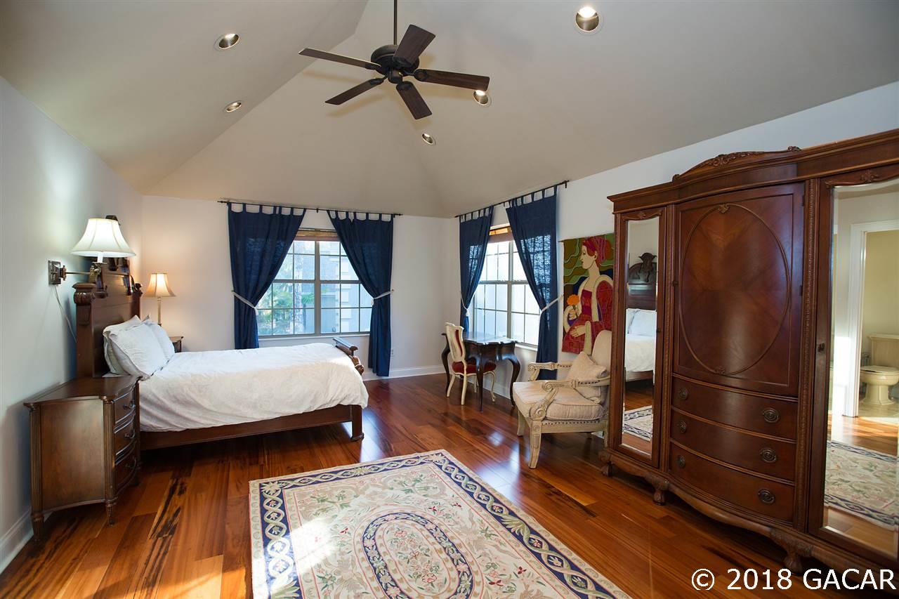 4626 Southwest 97th Terrace Gainesville, FL 32608 - Photo 23 of 30 The bonus room/4th bedroom is on the second floor with an en suite bathroom and a large walk-in closet. Adjacent is a climate controlled storage room and access to the attic.