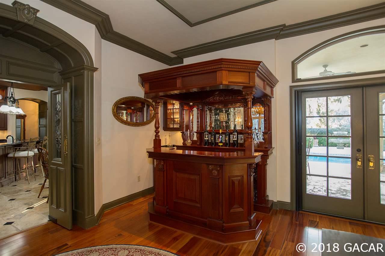 4626 Southwest 97th Terrace Gainesville, FL 32608 - Photo 6 of 30 Imported Pub wet bar custom made in England. Hand made swinging doors into the kitchen have leaded glass from England.