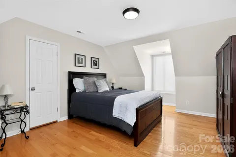 a bedroom with a bed and a refrigerator