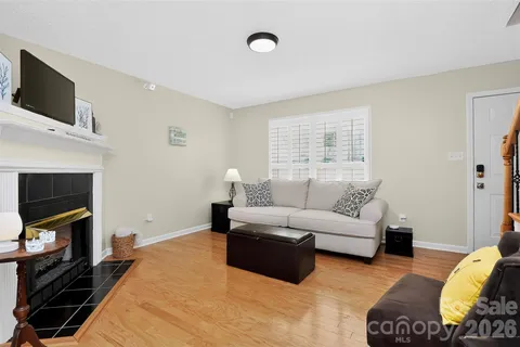 a bedroom with furniture a flat screen tv and a fireplace