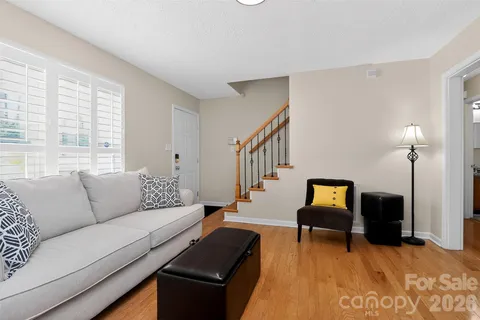 a living room with furniture and a piano