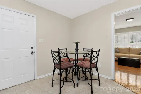 a view of a dining room with furniture and window