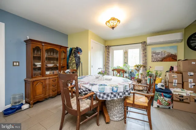 a view of a dining room with furniture and a potted plant