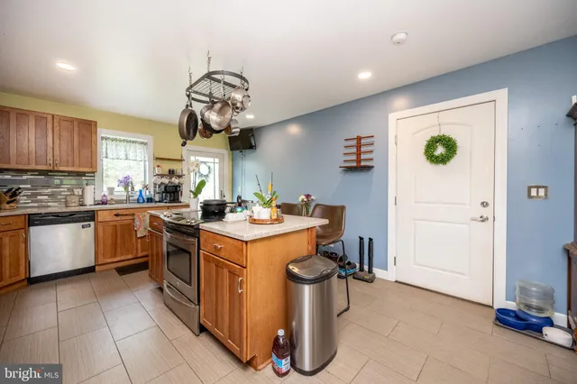 a living room with furniture a clock and a large window
