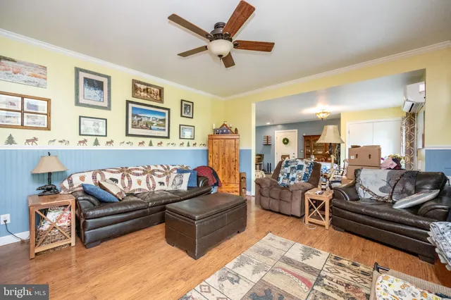 a bedroom with a bed and a wooden floor