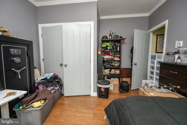 a bedroom with a large bed and flat tv screen on dresser