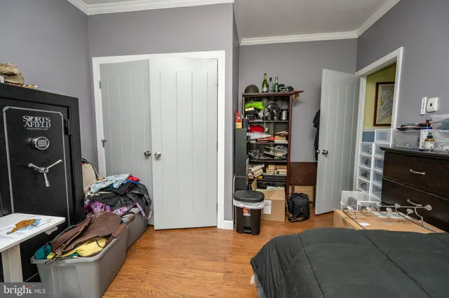 a bedroom with a large bed and flat tv screen on dresser