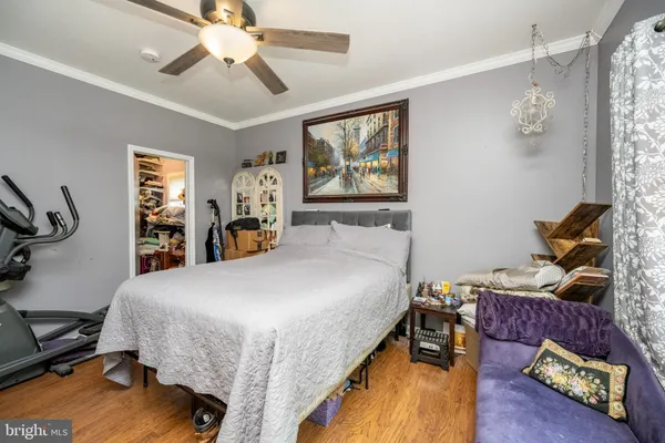 a bedroom with a large bed and flat tv screen on dresser