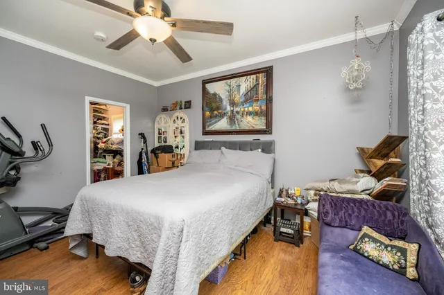 a bedroom with a large bed and flat tv screen on dresser