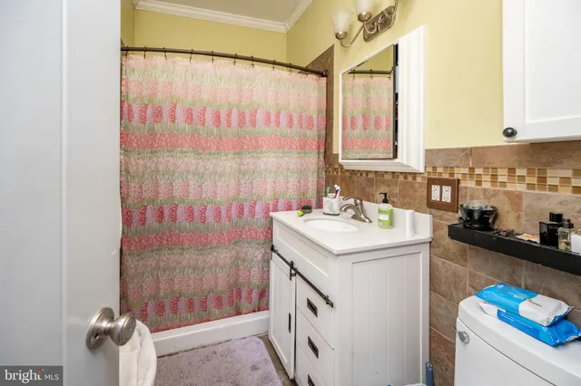 a bathroom with a sink mirror vanity and toilet