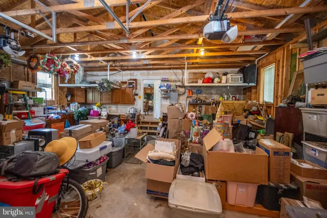 a view of a chair and table in backyard of the house