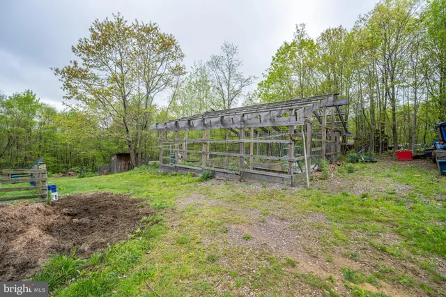 a aerial view of a house with a yard table and chairs
