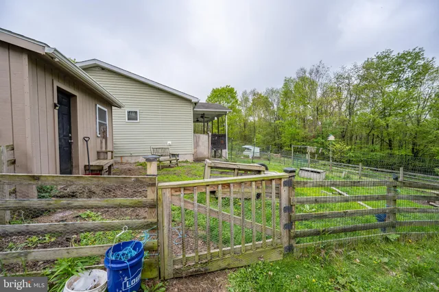 a aerial view of a house next to a yard