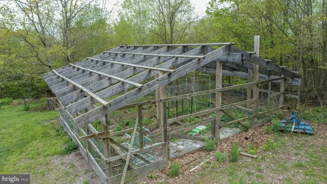 a dining room with stainless steel appliances furniture a rug and a kitchen view