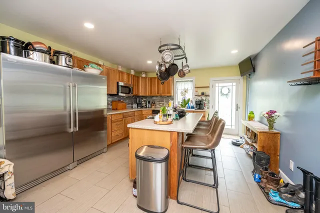 a kitchen with a stove cabinets a sink and a counter top space