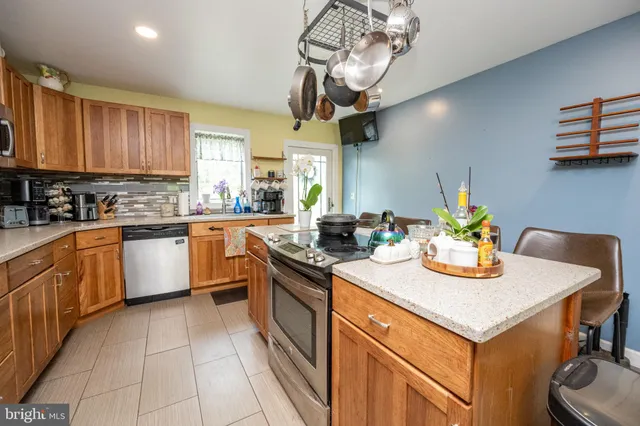 a kitchen with stainless steel appliances granite countertop a sink and cabinets