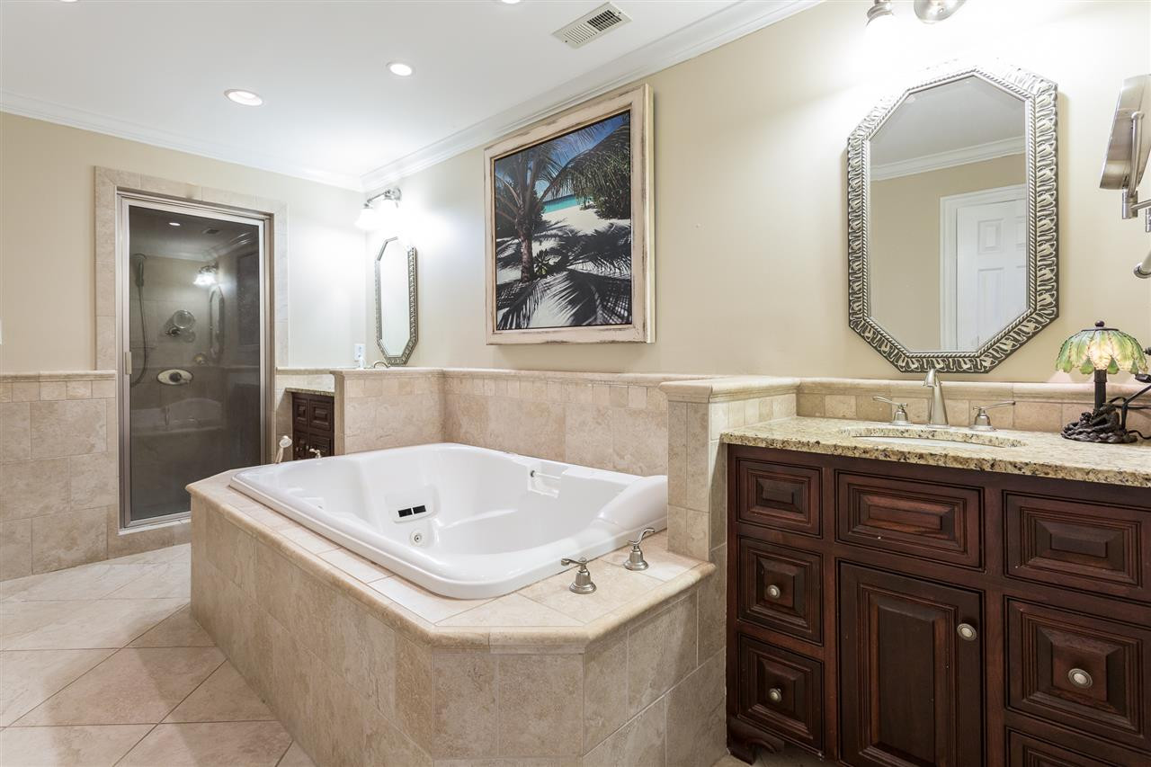 1001 Clingmans Place Raleigh, NC 27614 - Photo 27 of 30 The sumptuous spa-like bath in the lower level was extensively remodeled in 2017 and offers a double-width jetted tub, steam shower, two custom vanities with granite counter tops, towel warmer, and private water closet. Remodeled Full Bath with Steam Shower