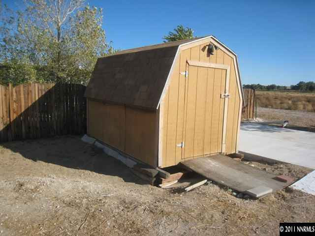 6263 Jacobs Road Fallon, NV 89406 - Photo 13 of 13 a view of backyard with small cabin and wooden fence