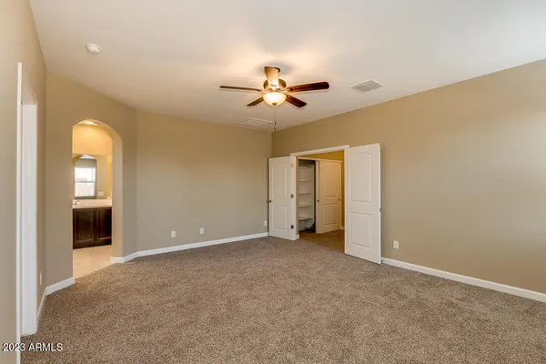 a bathroom with a granite countertop sink a large mirror and a shower