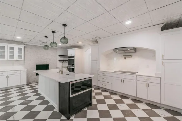 a kitchen with a stove a sink and a refrigerator