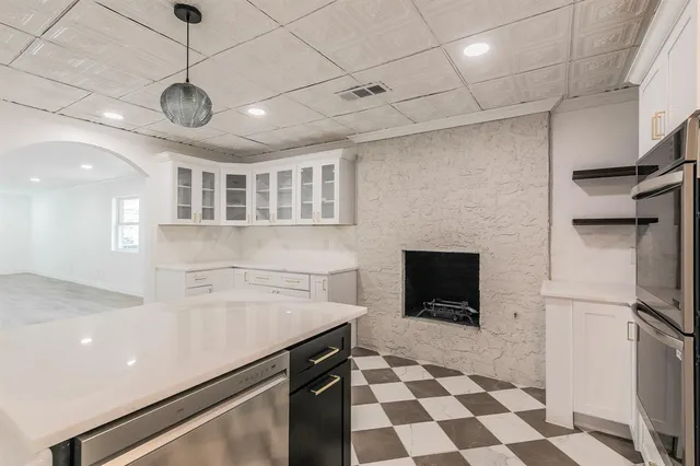a hallway with a black white checkered table and chairs