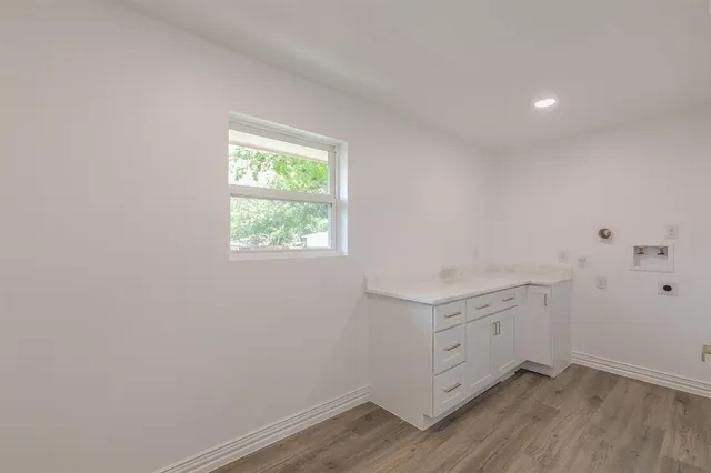 a room with cabinets and wooden floor