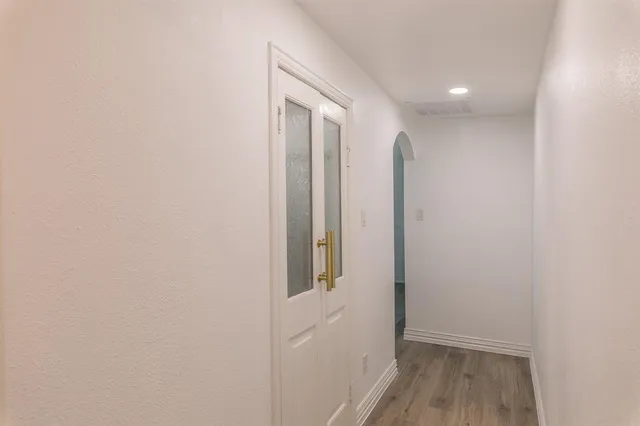 a view of hallway with wooden floor